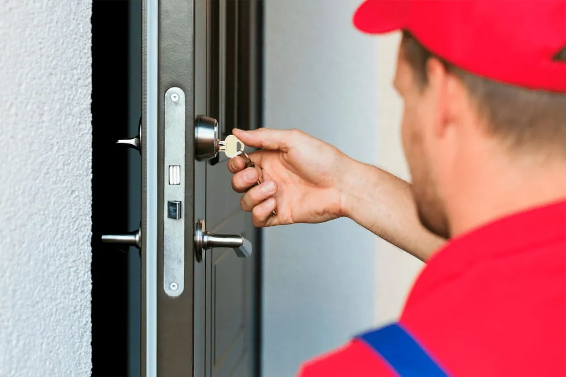 Cerrajero instalando una cerradura en una puerta de vivienda