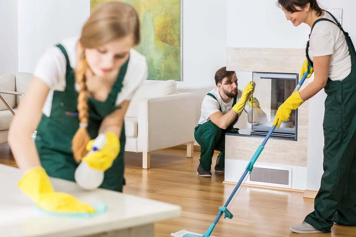 Equipo de limpieza trabajando en el salón de un piso, empresa de limpieza en Madrid